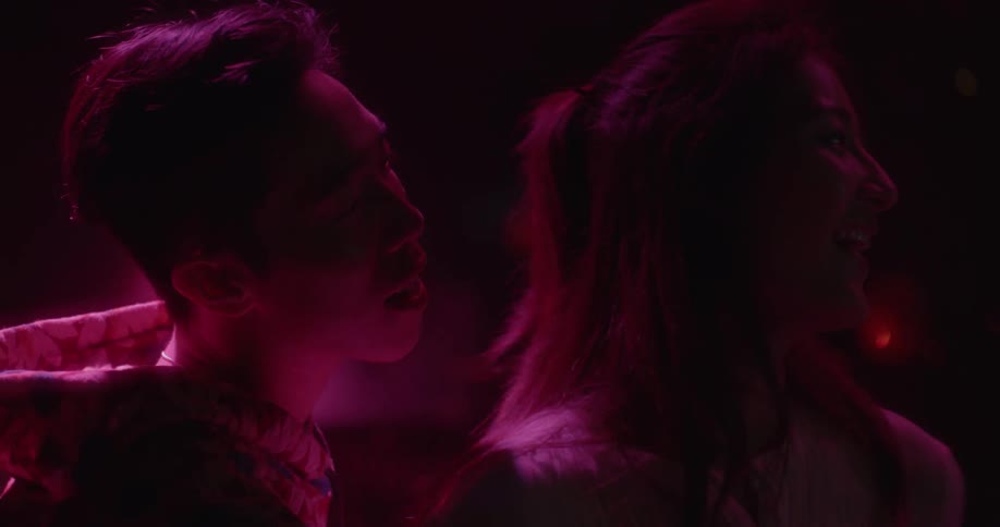 A man and woman sing to each together and laugh