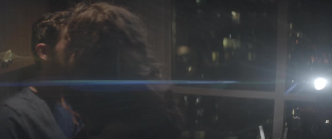 Couple making out in a kitchen at night