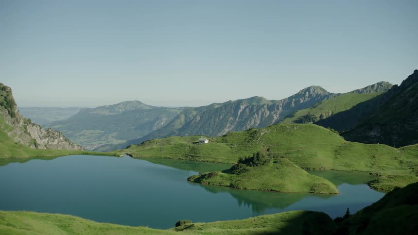 Green mountains surround a big lake
