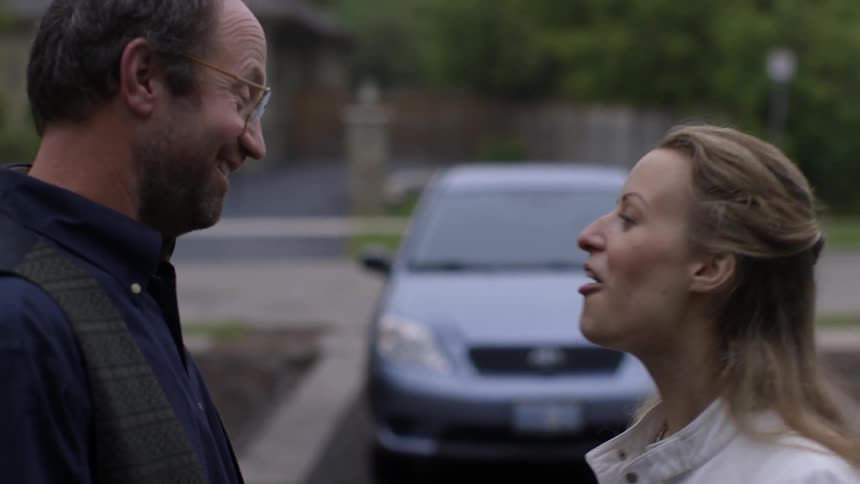 Man and woman talk and man holds up car keys