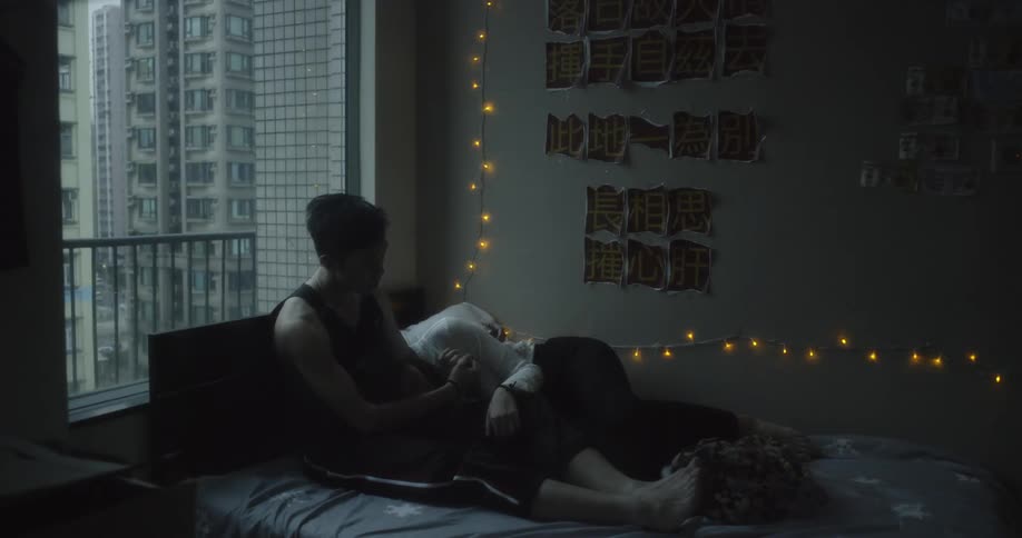 Man and woman lay in bed cuddling