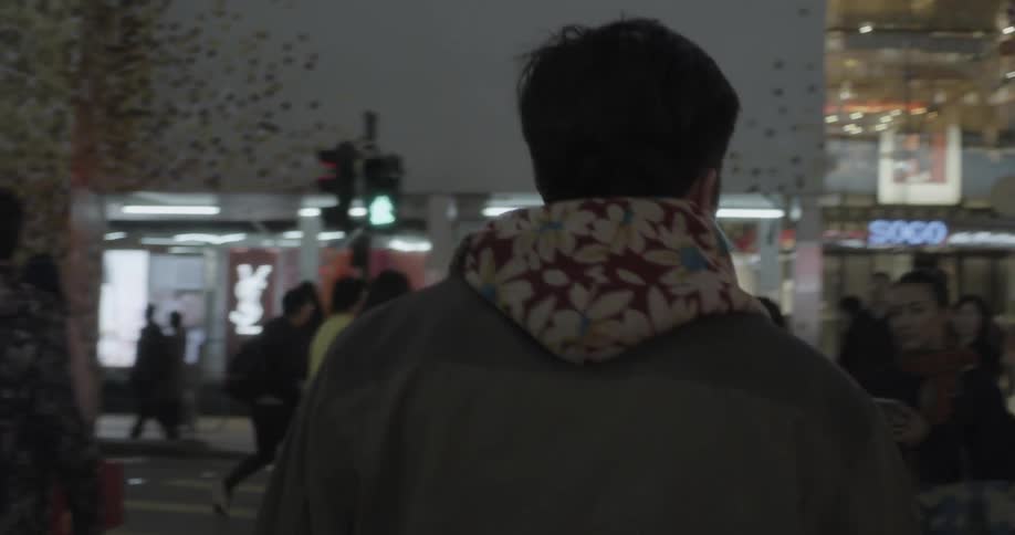 A crowd is traveling in the city at night