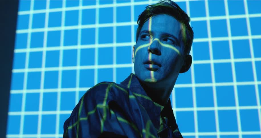 Man's face illuminated by blue and green light