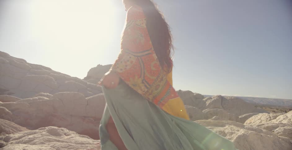 A woman walks through the desert