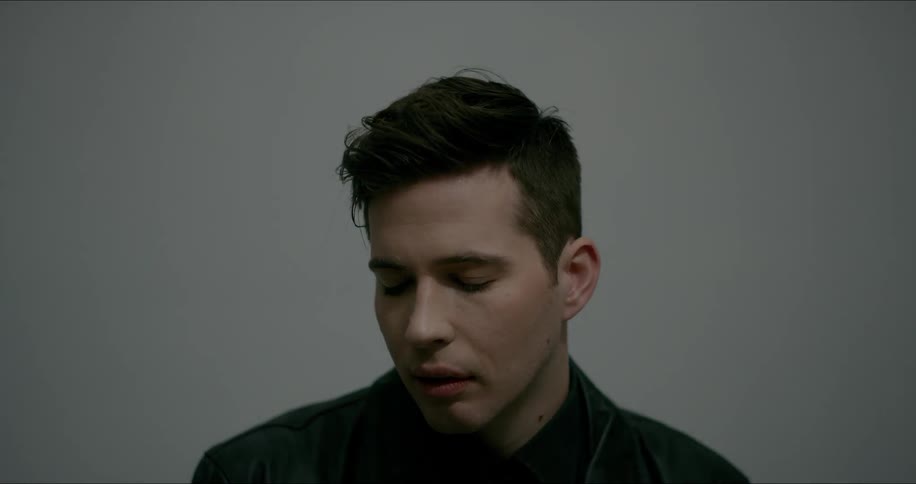 A man opens his eyes and looks forward