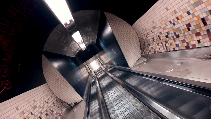 Moving fast down an empty escalator into the subway