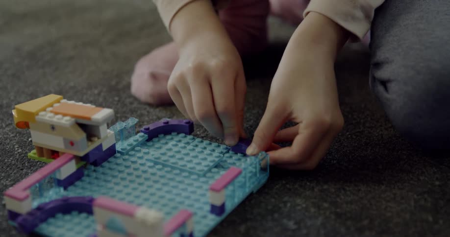 A child is playing building some legos