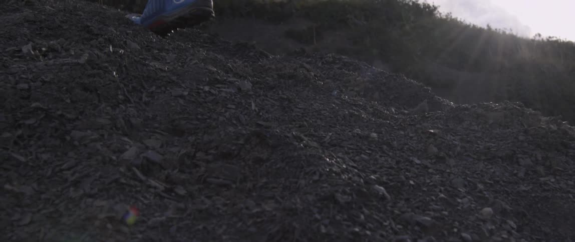 A person moves up the steep hill