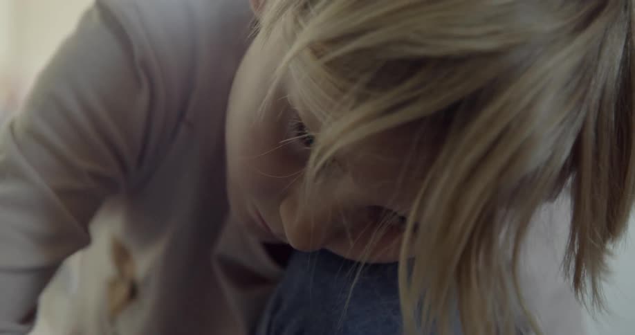 A young child plays on the floor