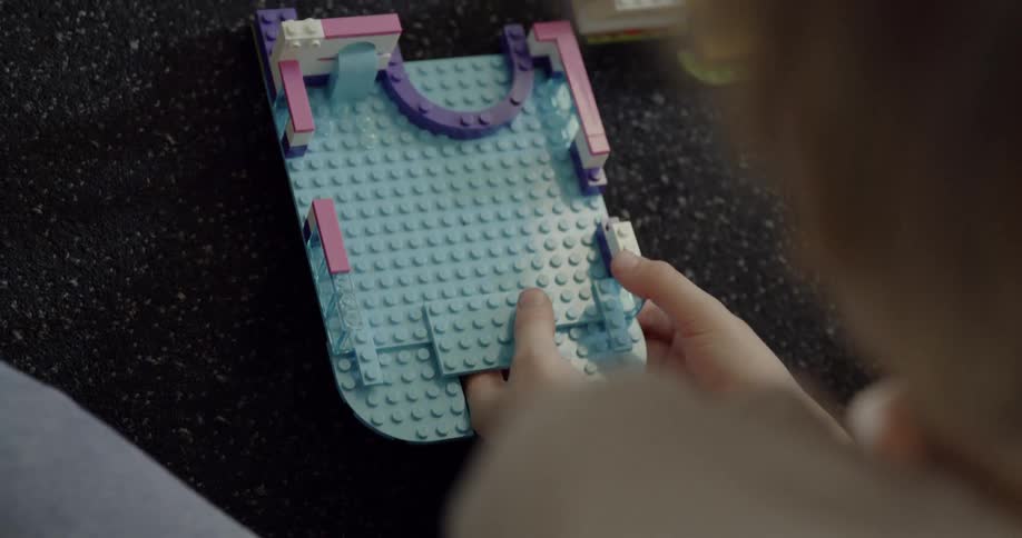 A young child plays with legos