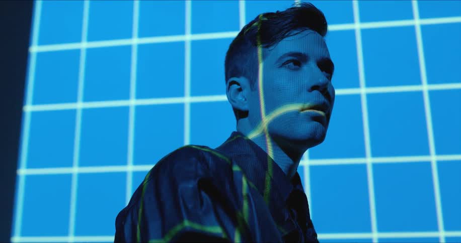 Blue and white lights shine on a man