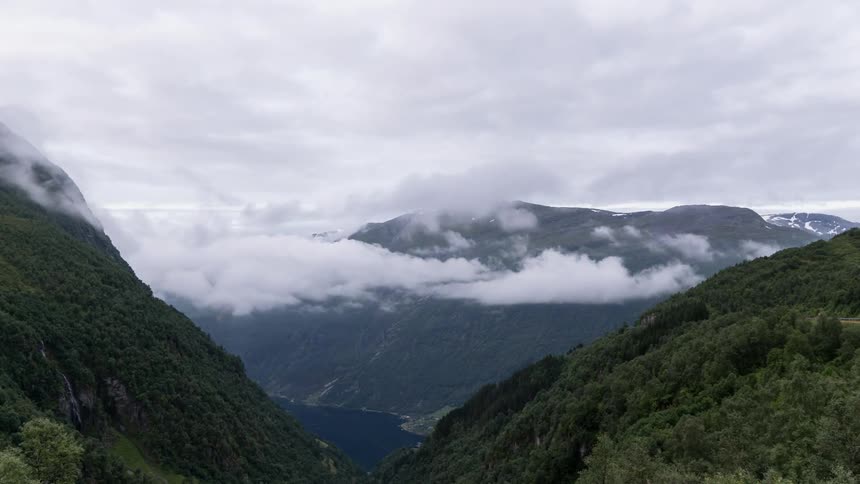 The mountains are full of green with swirling clouds