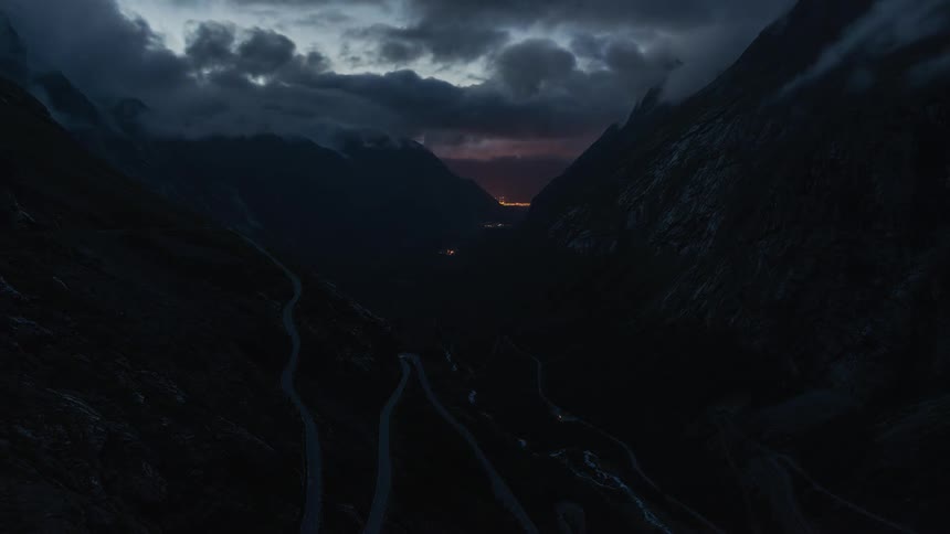 Clouds rolling over the darkening mountain road