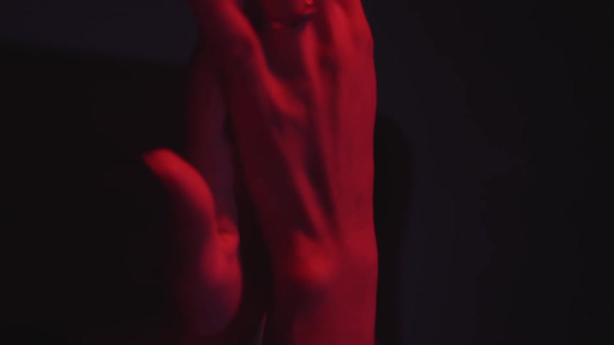 Close up of hands illuminated by red light