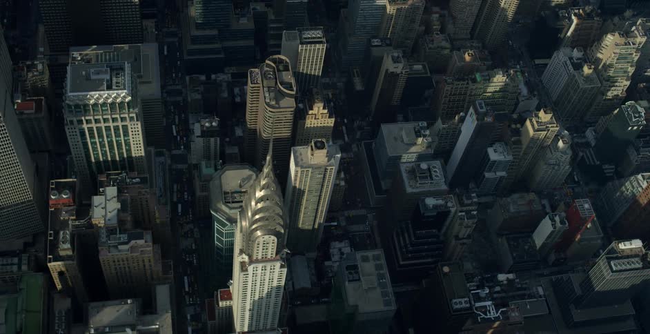 Aerial view of a city with the sun casting shadows on some buildings