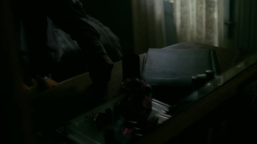 An old man pours bullets out of a cup onto a dresser top