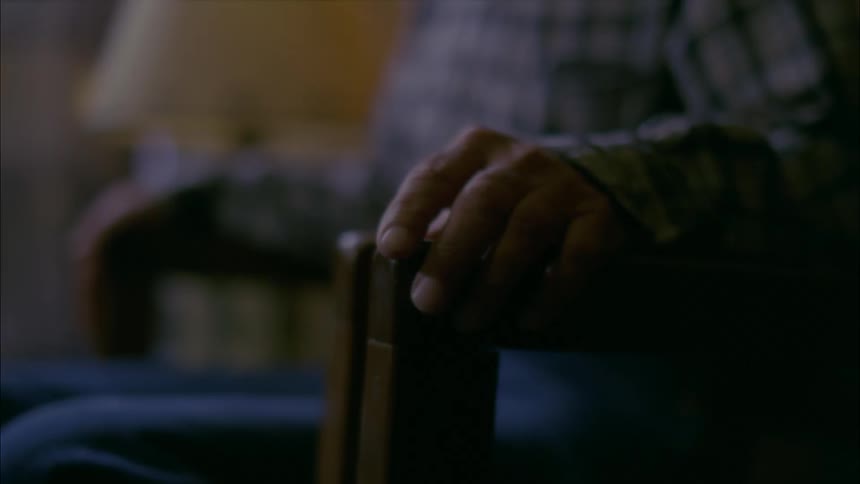 Man tapping his fingers on the arm of chair that he is sitting in