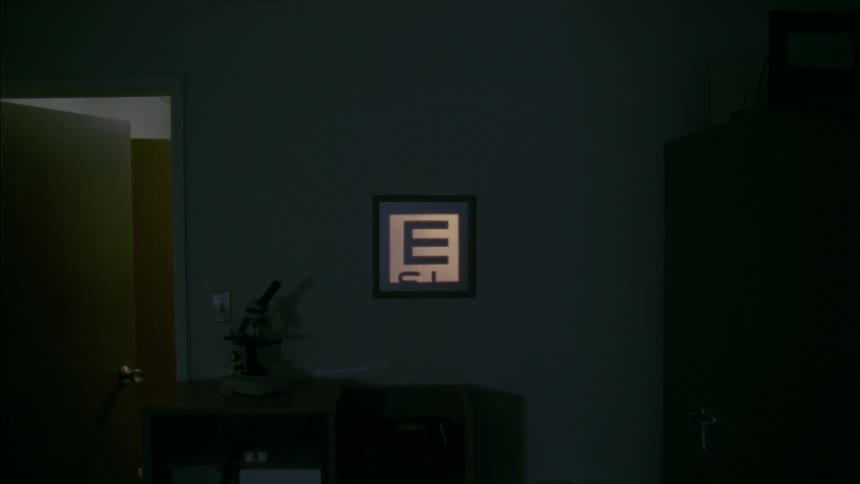 Letters in an eye chart are projected on a wall