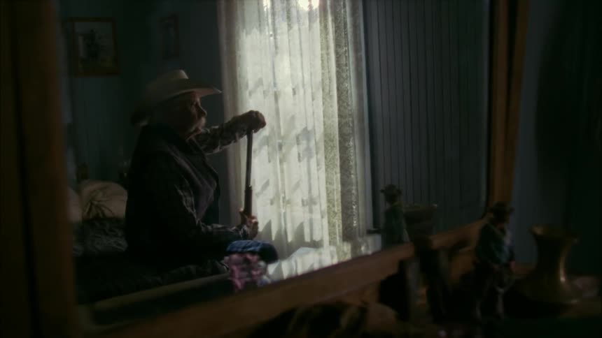 A man examines and takes apart his rifle