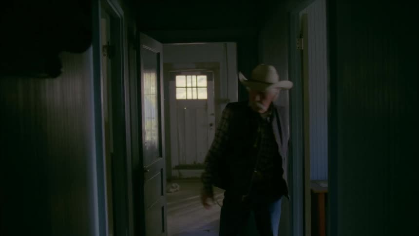 An old cowboy enters a house and searches for something