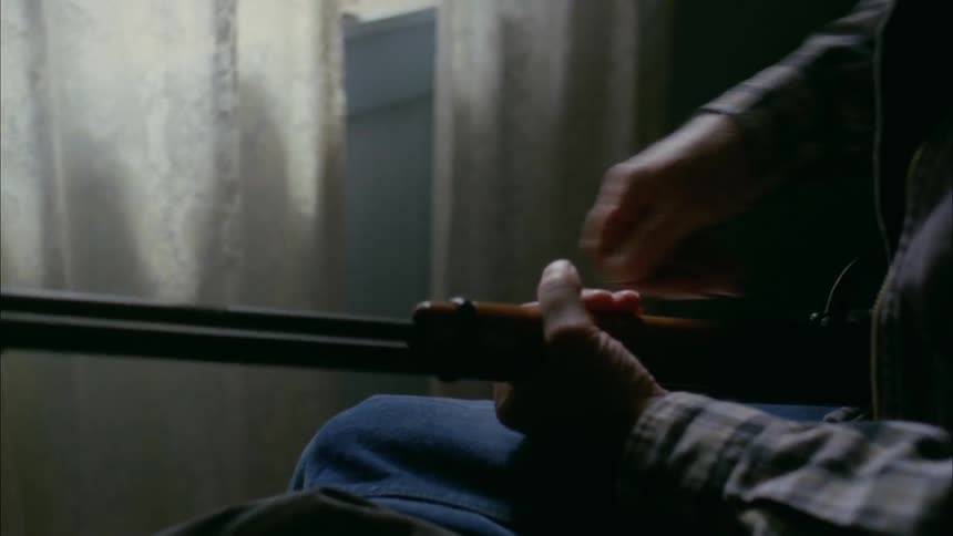 A man takes apart a rifle