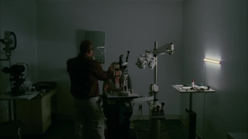 Elderly woman sits in a chair at the optometrist office