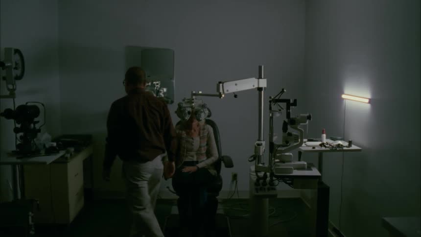 Woman gets eyes checked at an optometrist's office