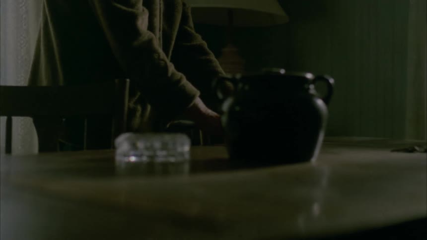 A person walks around a table and trips over a chair