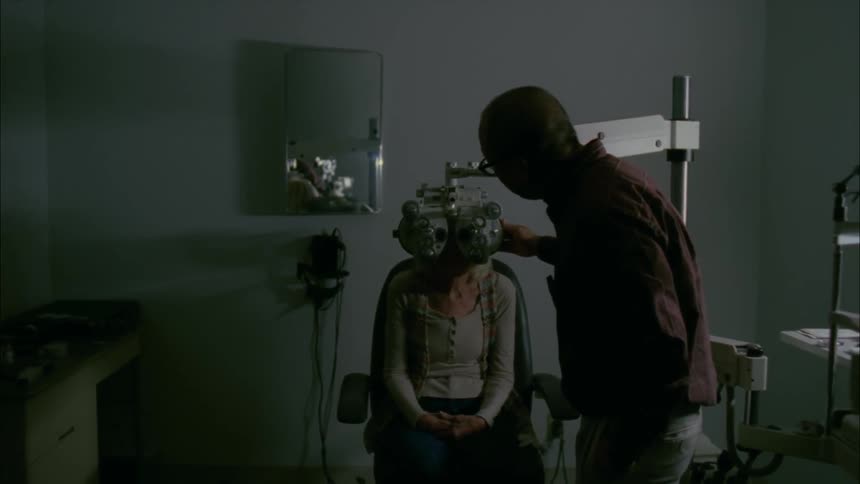An eye doctor is giving an examination
