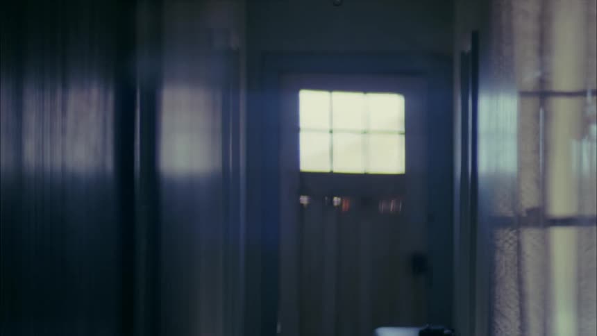 A man is leaving through a door in a house