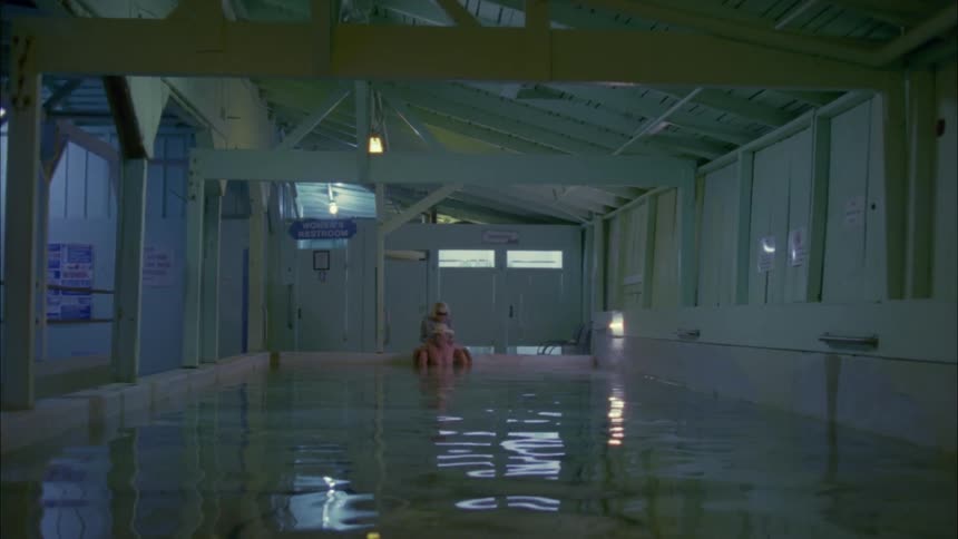Elderly couple sits in an indoor pool