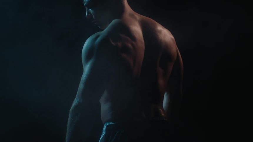 Strong man standing still looking downwards