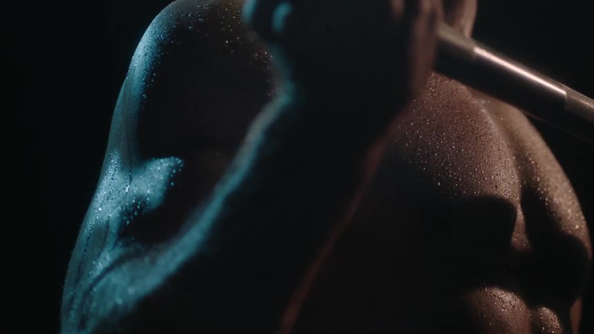 A close up shot of a man lifting weights