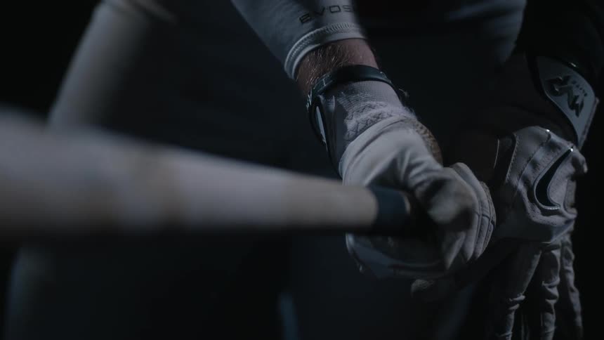 Person tightens grip around baseball bat