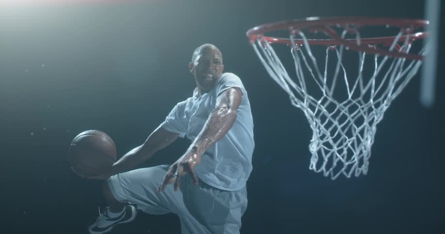 Man runs up and dunks a basketball