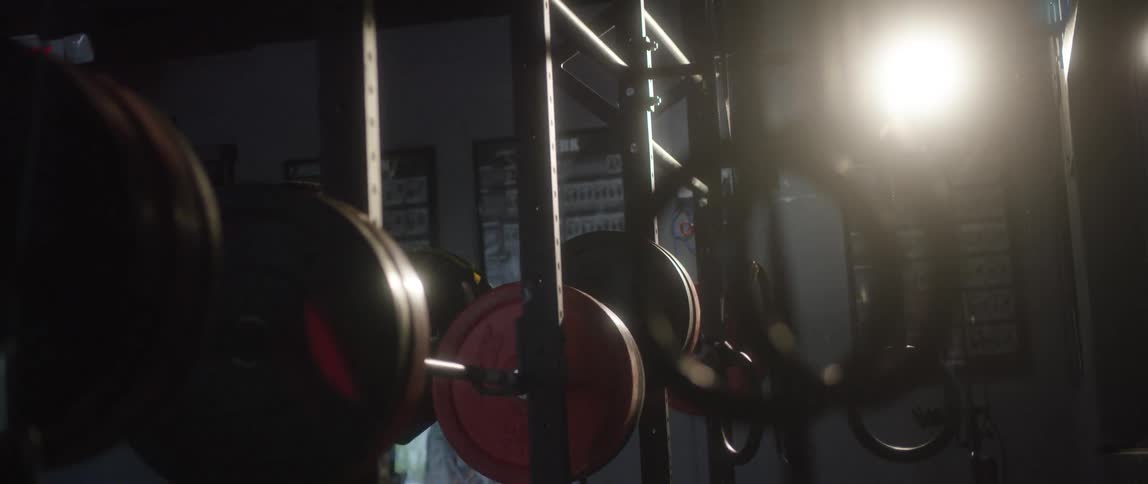 Man loads weights onto gym equipment