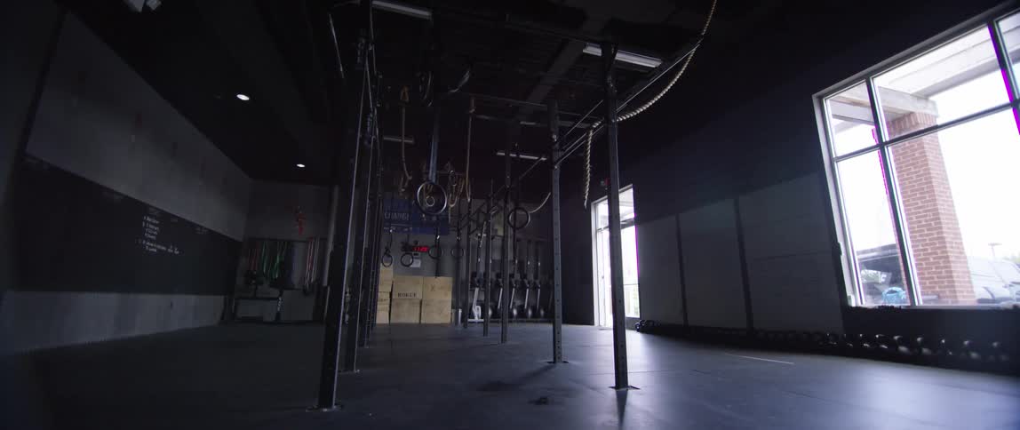 Equipment sits unused inside an empty gym