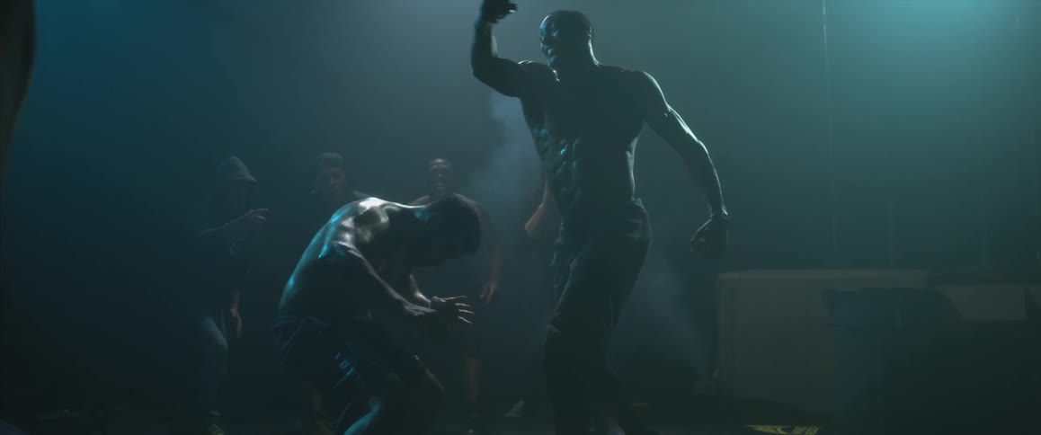 Two men fighting, one ducks a large swing of a fist
