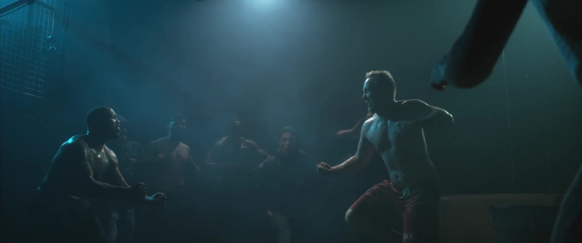 Smokey room with two men charging each other to fight