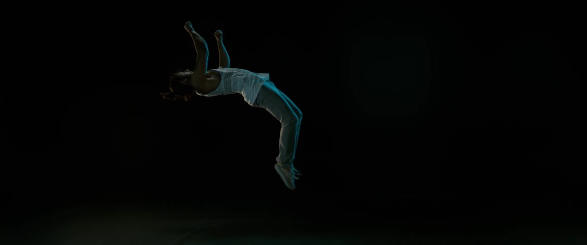 A slow motion shot of a man doing a backflip