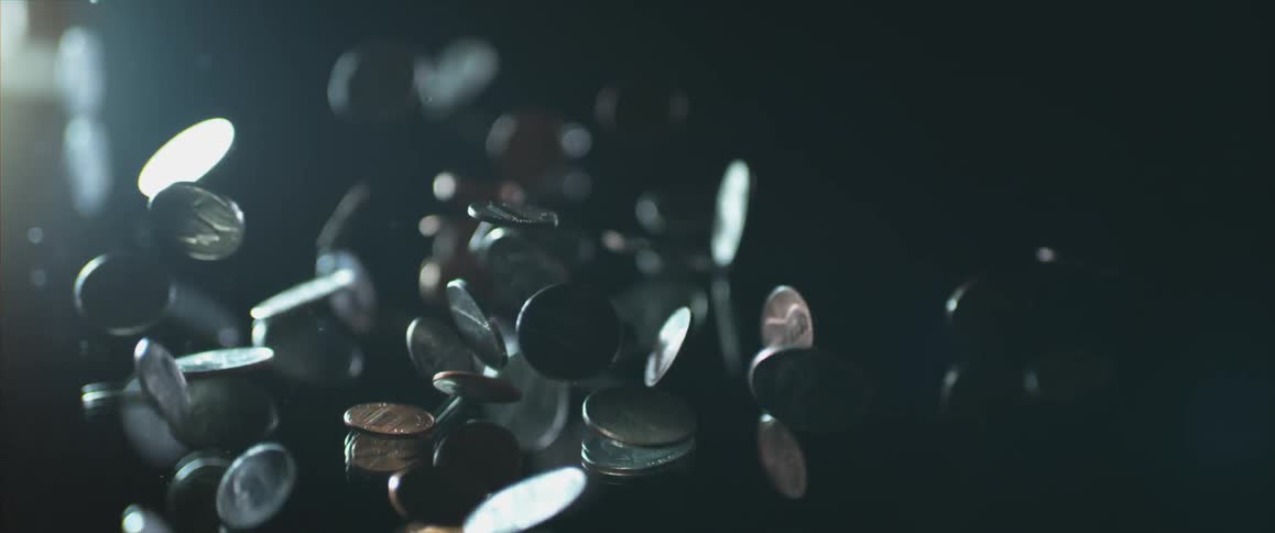A bunch of coins fall and bounce around