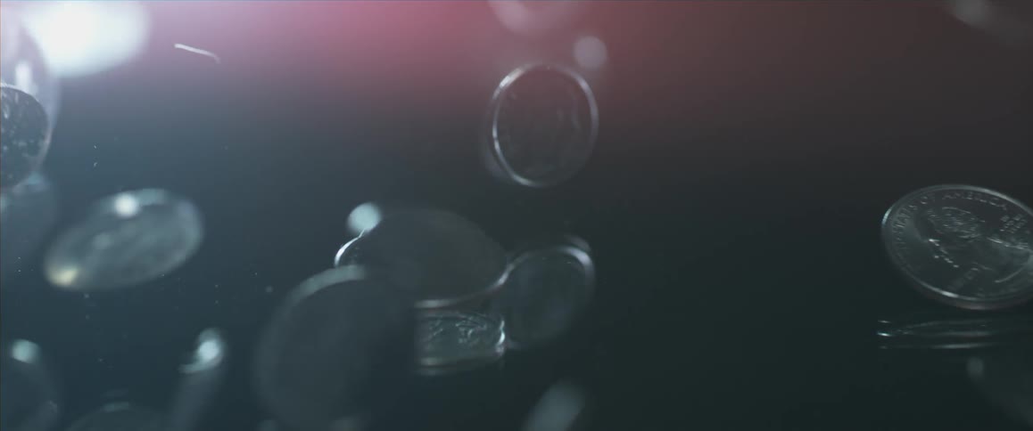 Coins dropping on a table