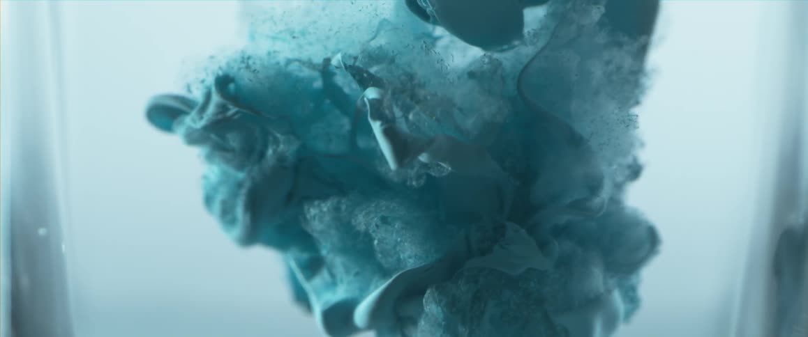 A slow motion shot of a thick liquid being poured into water