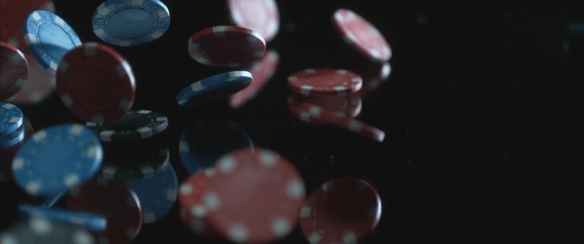 Poker chips falling onto a mirrored surface