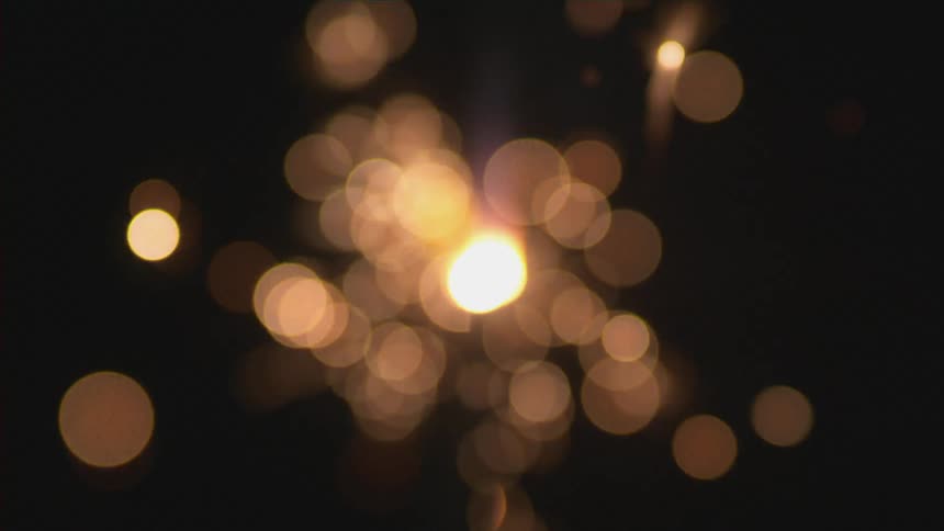 A sparkler slowly going off in a dark area