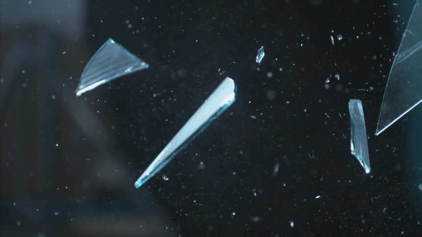 Close up of glass shards flying through the air