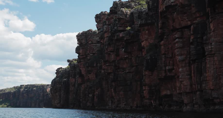 Water ripples next to a rocky cliffside