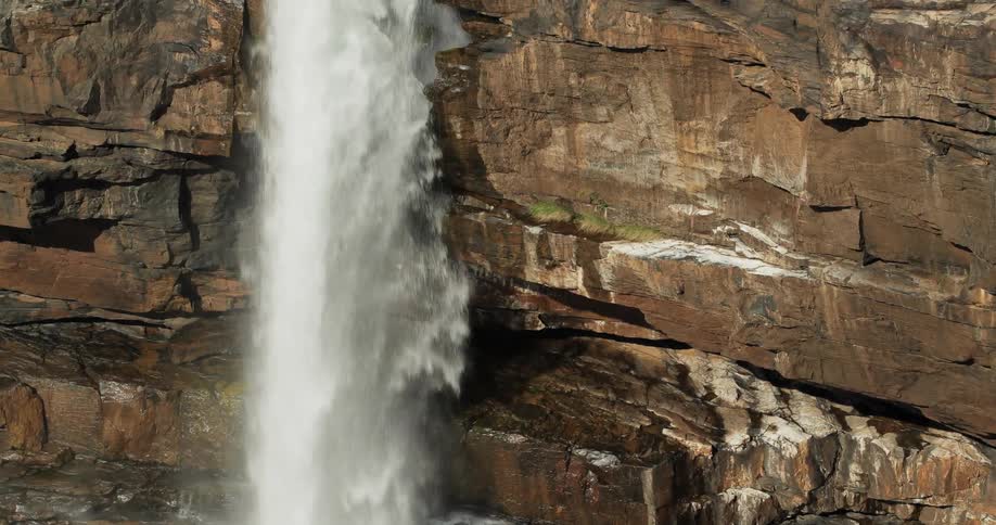 Water flows and splashes below from a waterfall
