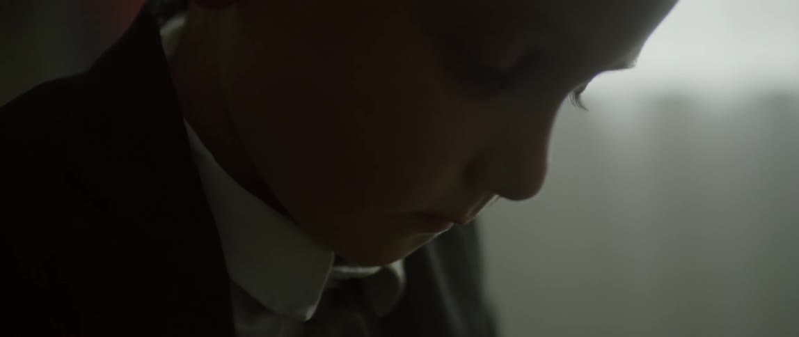 A child spoons some soup into his mouth