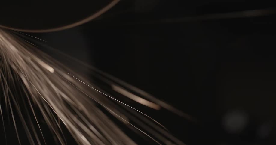 A person using a grinder and seeing the sparks up close